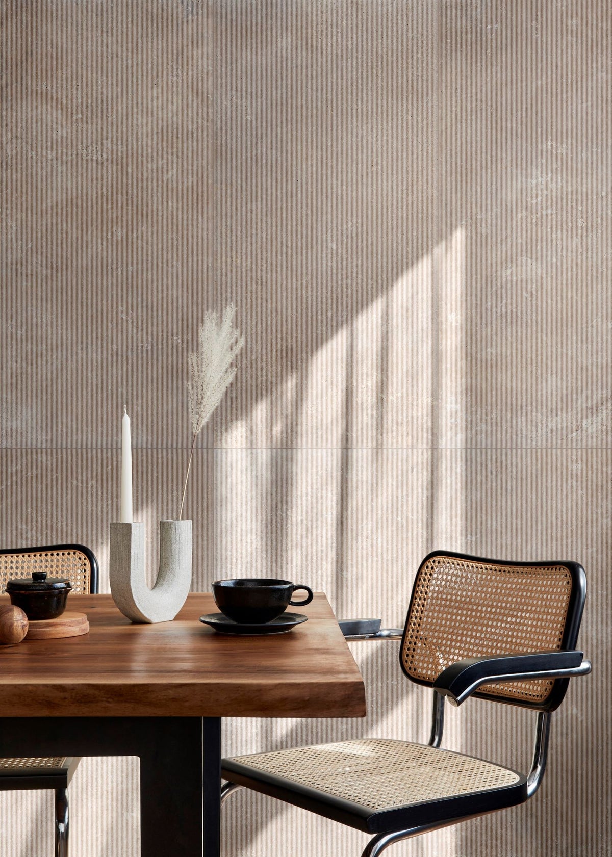 Soft daylight falls across a styled seating nook, with Travertine Veincut Canetto 3D Beige Matte tile creating a warm backdrop.