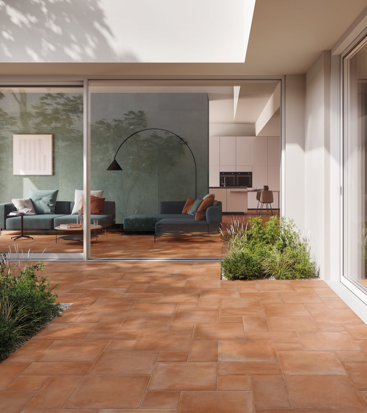 Modern home with ElitTile Crete R11 Safe LFT terracotta patio tiles, seamlessly connecting to a chic living room.