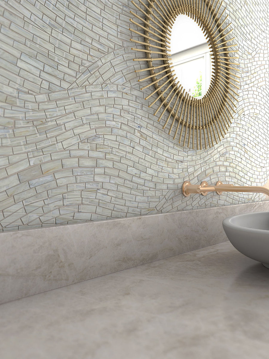 Bathroom featuring ElitTile Tile & Stone natural stone wall tiles, a sunburst mirror, gold faucet, and vessel sink.