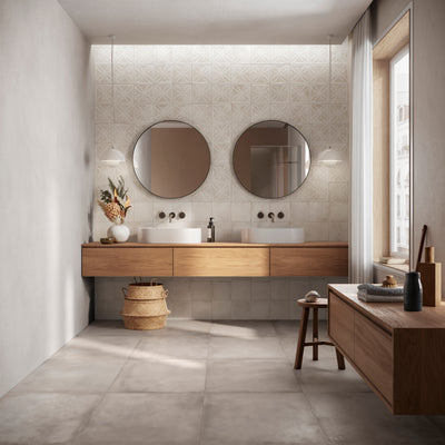 Modern bathroom featuring ElitTile Amuri decorative tiles on the wall behind a double vanity with circular mirrors.