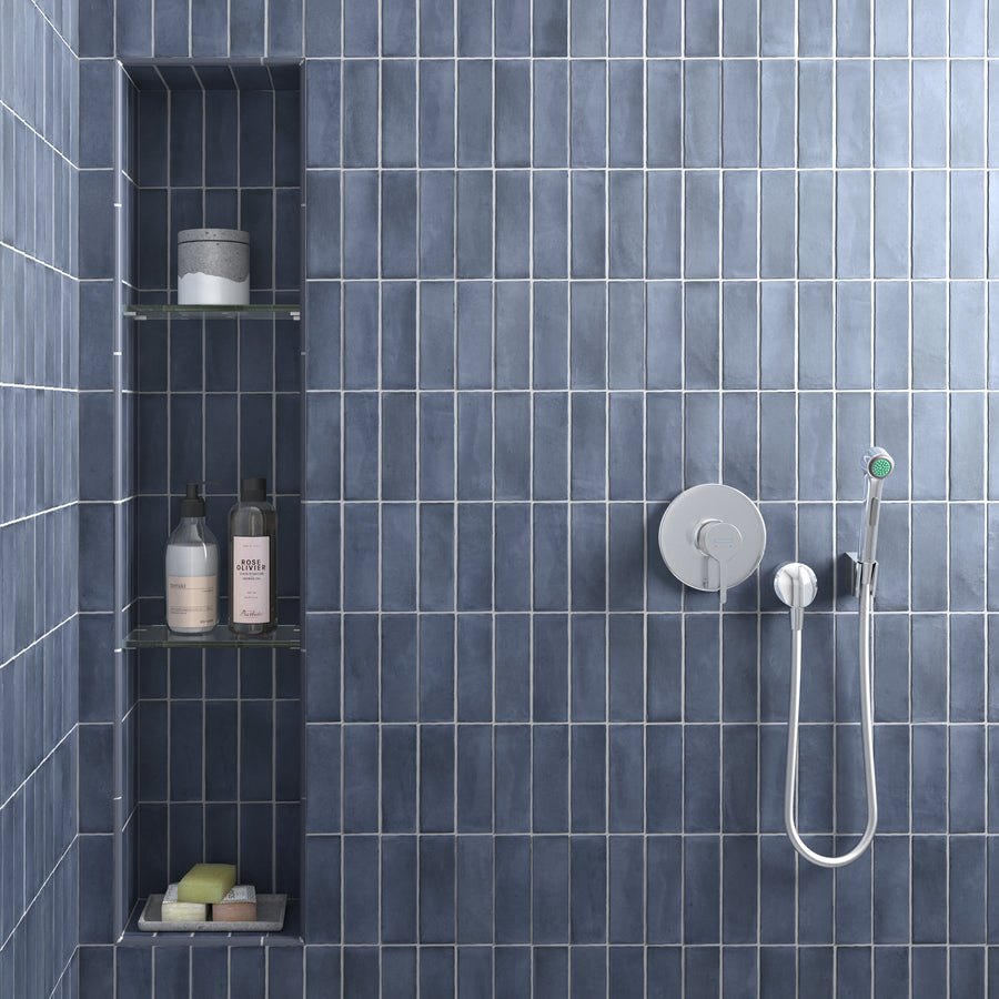 Modern ElitTile Tile & Stone shower featuring blue-grey vertical porcelain subway tiles, built-in niche, and chrome hardware.