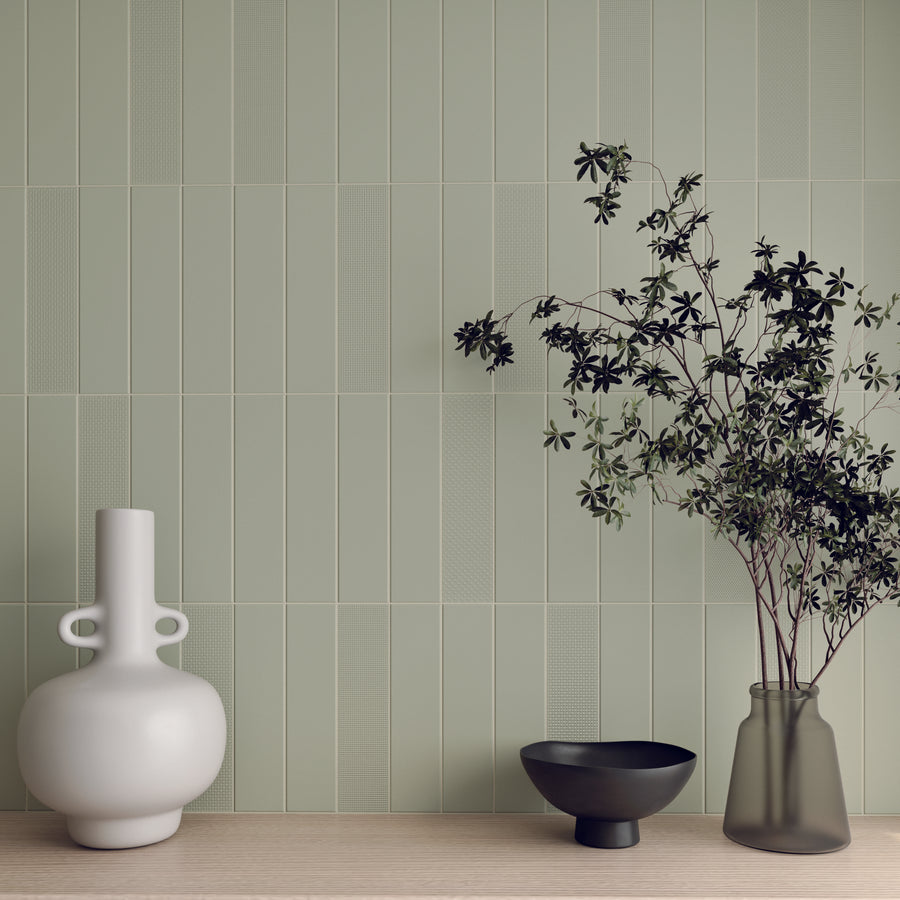 ElitTile Tile & Stone ceramic wall tiles in light green, featuring smooth and textured vertical patterns with decor.