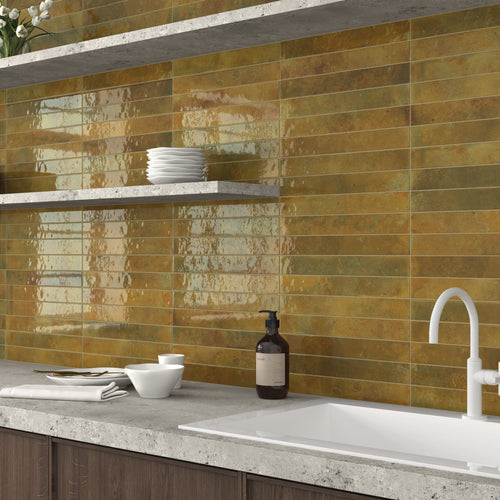 Bali Moss 2x16 glossy ceramic tile used as a kitchen backsplash with earthy green tones and reflective finish