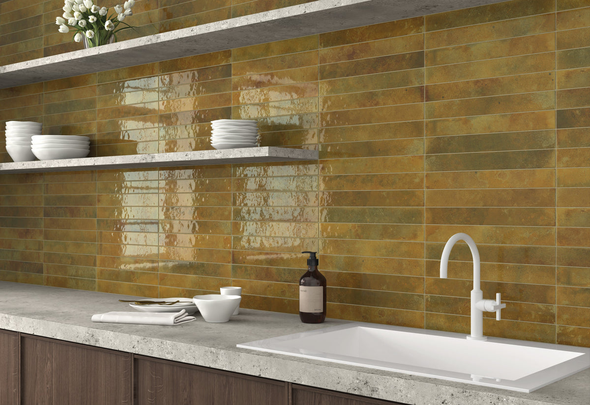 Bali Moss 2x16 glossy ceramic tile used as a kitchen backsplash with earthy green tones and reflective finish