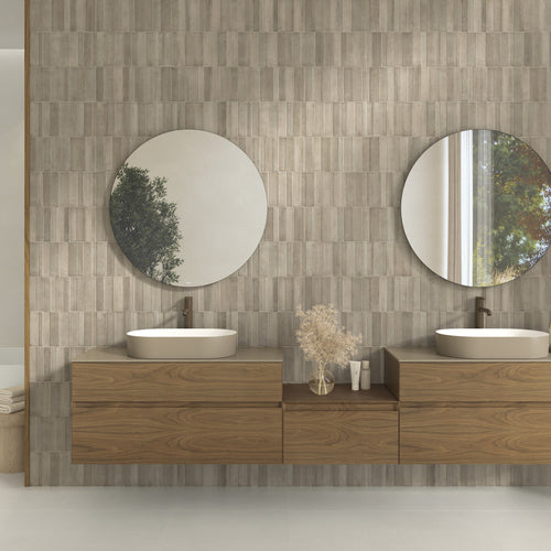 Slant 3D Taupe 16x48 matte ceramic tile installed on a bathroom vanity wall with soft taupe texture