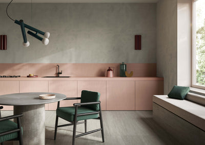 ElitTile Dorset LFT grey floor tiles in a contemporary kitchen with pink cabinets, dark green chairs, and a window.