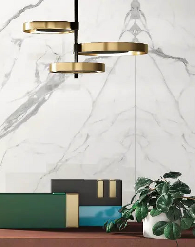 Modern interior showcasing ElitTile book-matched slabs: white marble porcelain with grey veining creating symmetrical mirror-image pattern on feature wall from countertops collection