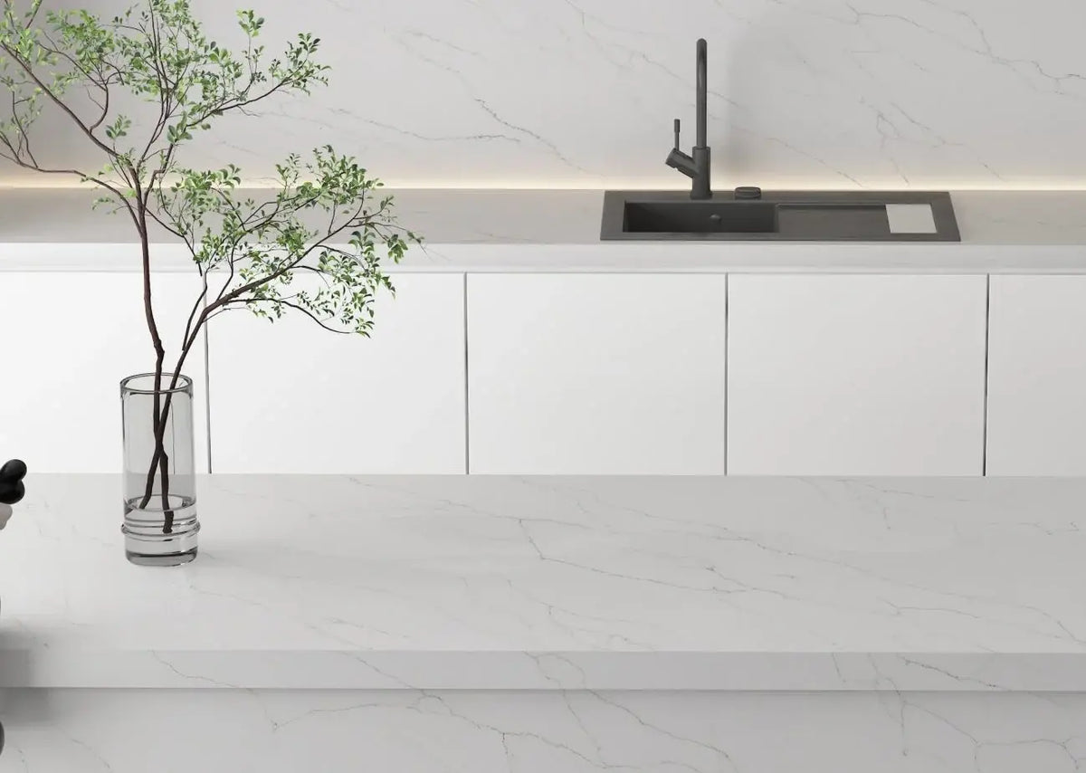 Modern minimalist kitchen featuring ElitTile quartz prefab countertops in white with grey veining, integrated backsplash and sink from premium collection